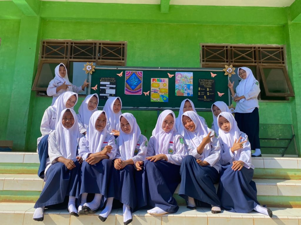 Siswa kelas 8B berfoto bersama setelah menyelesaikan pemasangan mading periode ke-3.